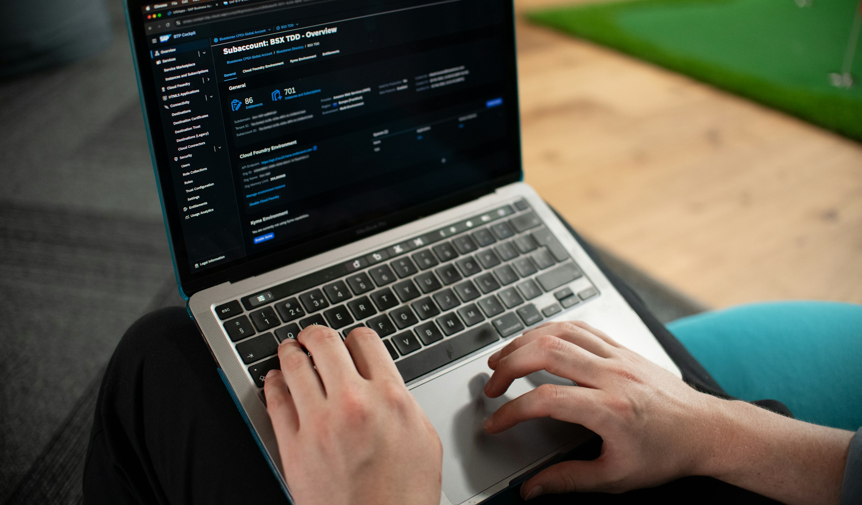 Hands typing on a laptop keyboard at a desk