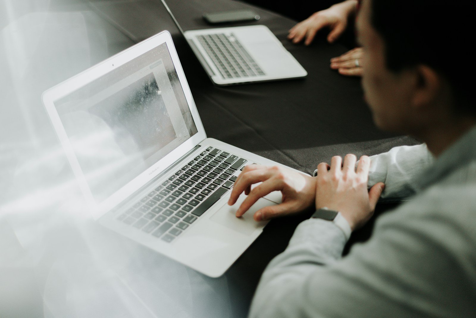 A man working at a laptop in a modern office
