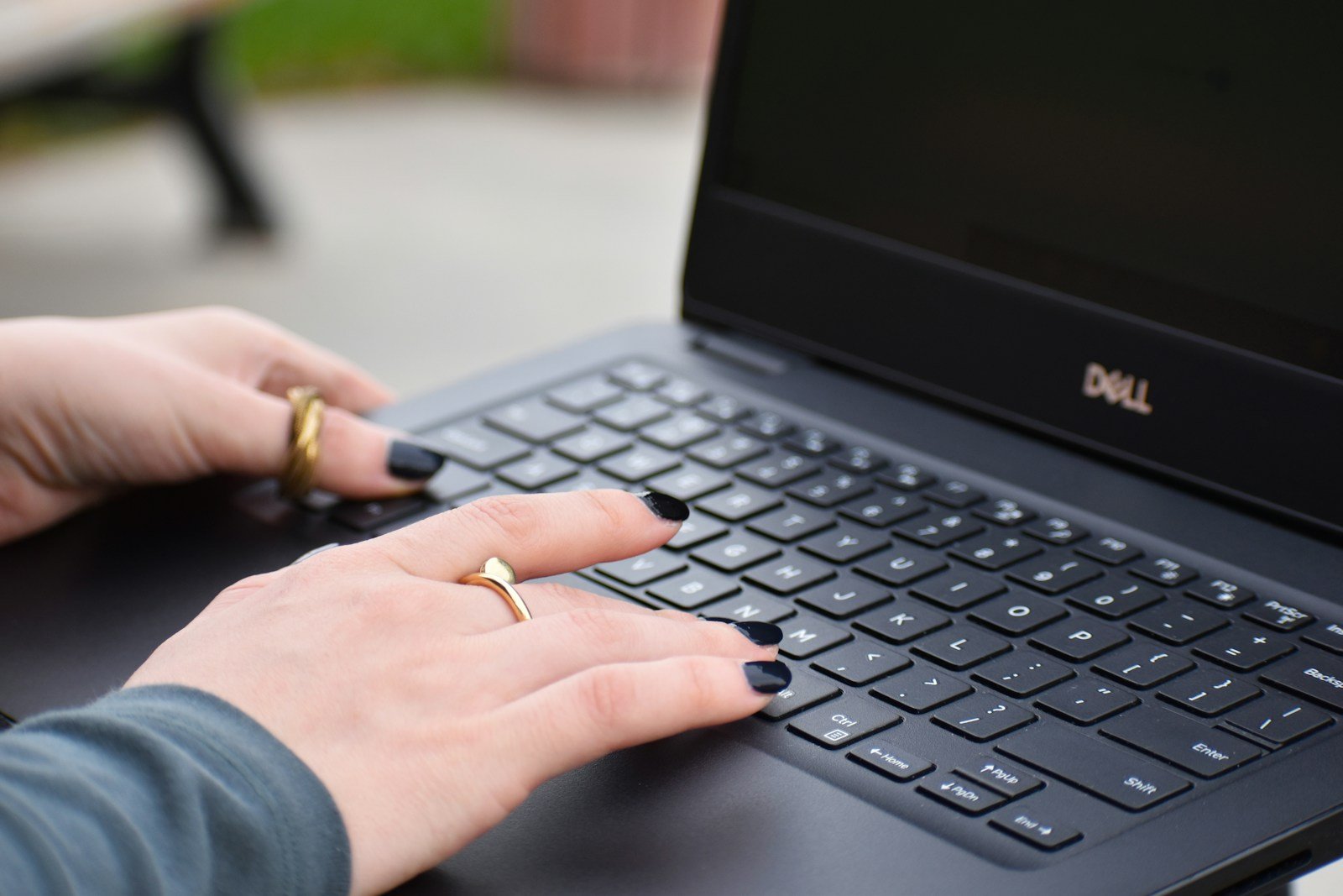A young businesswoman typing on a laptop keyboard
