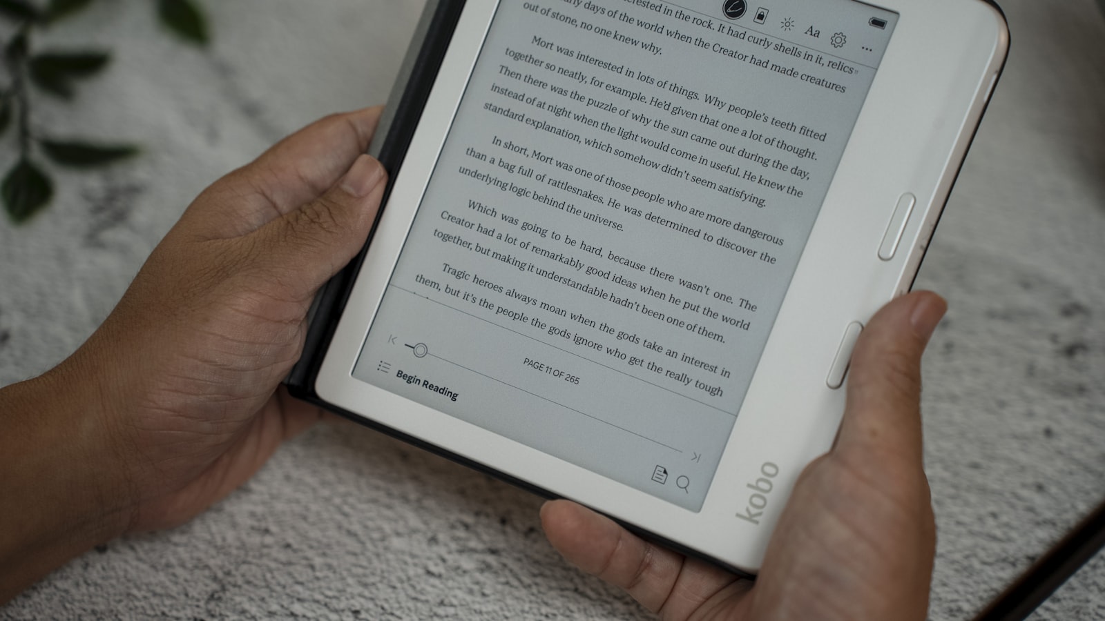 A person holding a tablet displaying an ebook